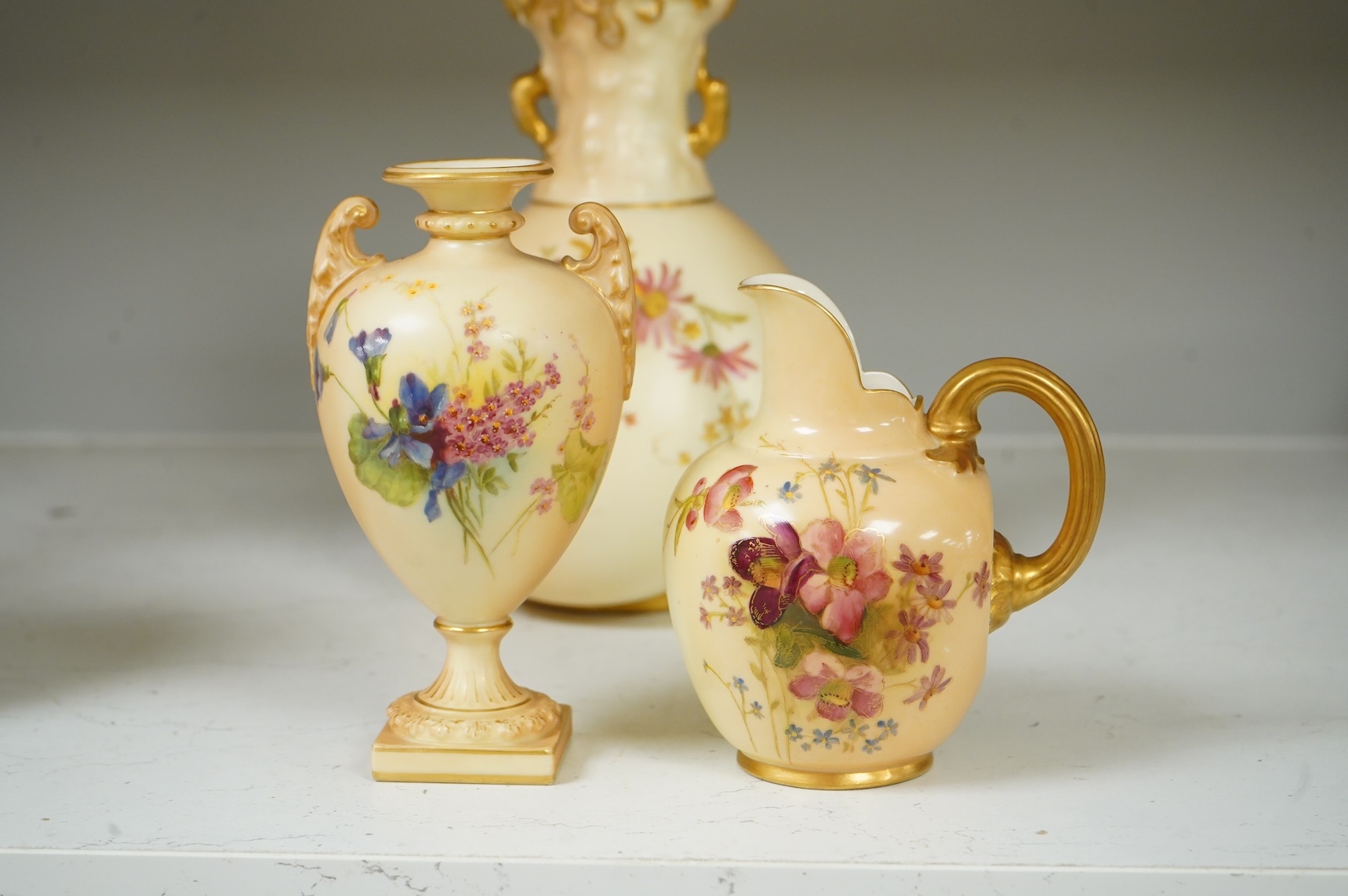 Three pieces of Royal Worcester blush ivory porcelain vessels, tallest 20cm
